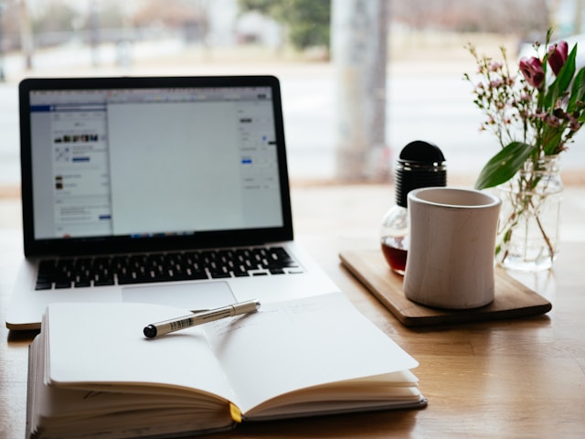 Laptop and documents on a workspace